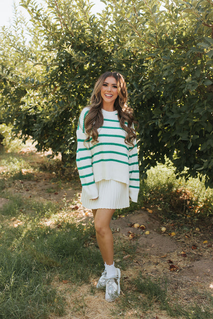 THE LORALI PLEATED MINI SKIRT IN CREAM