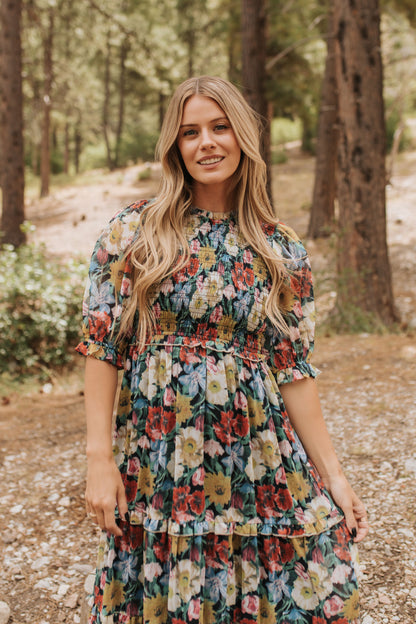 THE ASHTON SMOCKED FLORAL MIDI DRESS IN BLACK