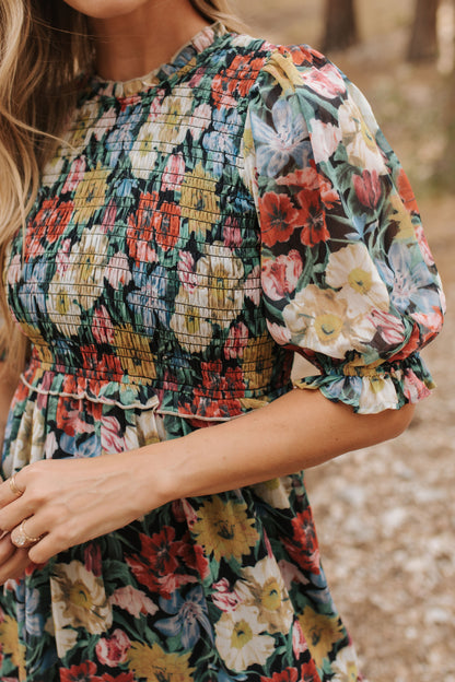 THE ASHTON SMOCKED FLORAL MIDI DRESS IN BLACK