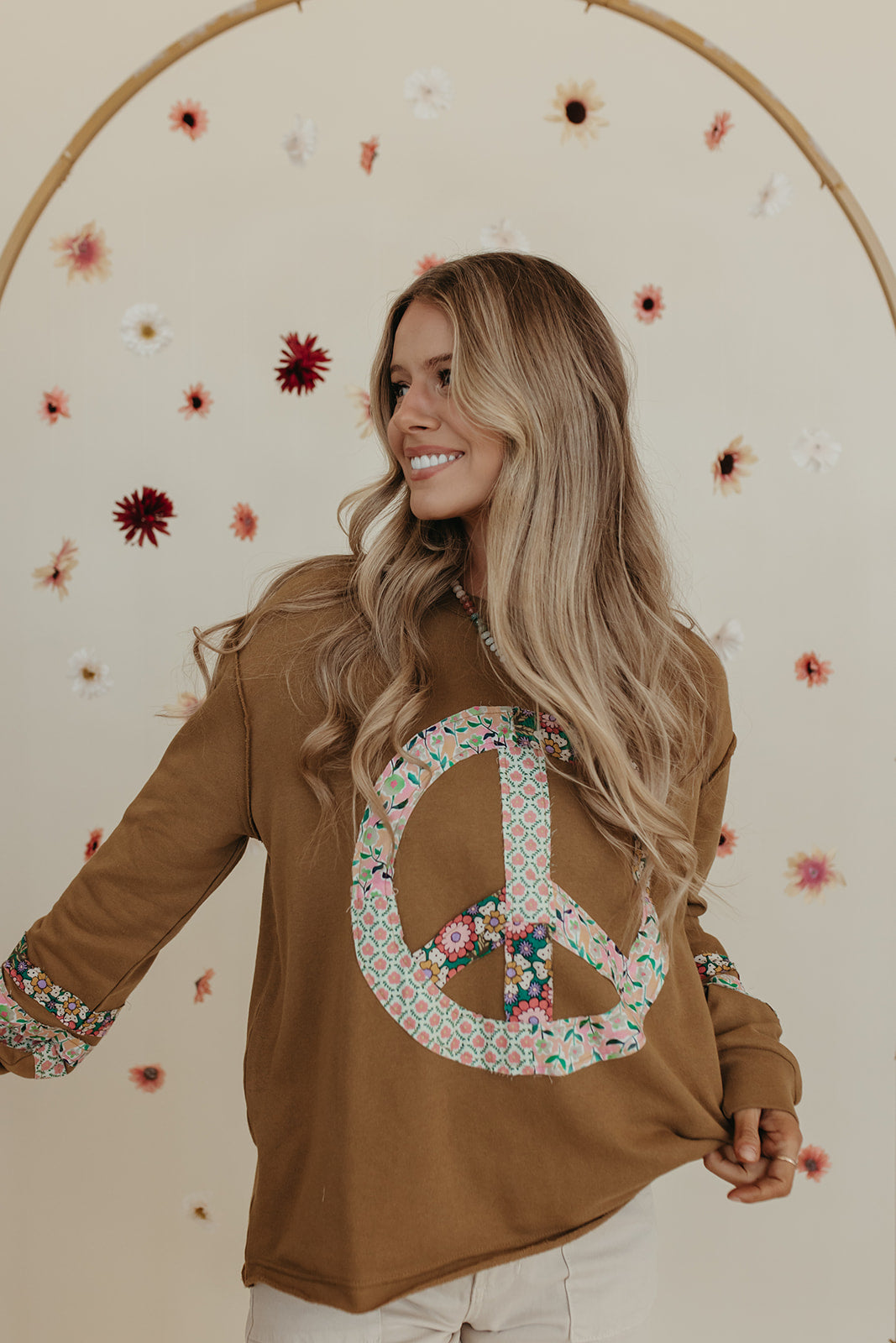 THE PORSCHA PEACE PATCH LONG SLEEVE TOP IN BRONZE