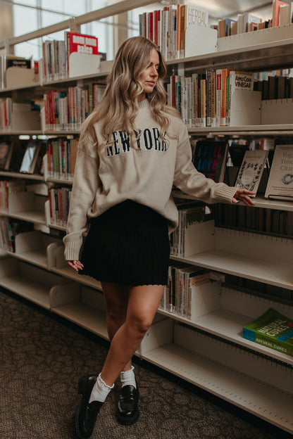 THE LORALI PLEATED MINI SKIRT IN BLACK