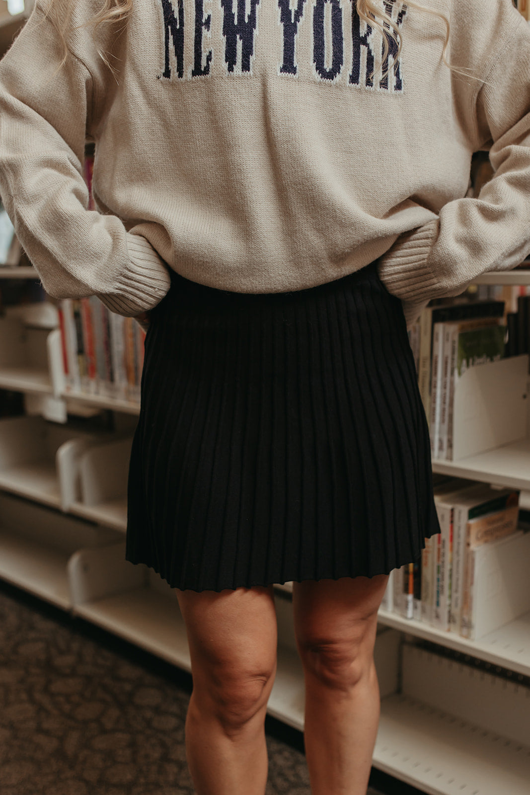 THE LORALI PLEATED MINI SKIRT IN BLACK