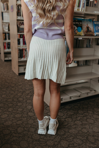 THE LORALI PLEATED MINI SKIRT IN CREAM