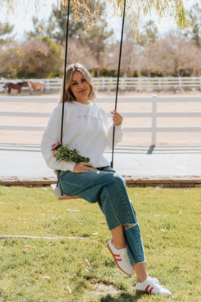 THE EMBROIDERED HOLIDAY BOW PULLOVER IN PINK