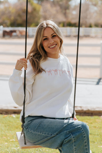 THE EMBROIDERED HOLIDAY BOW PULLOVER IN PINK