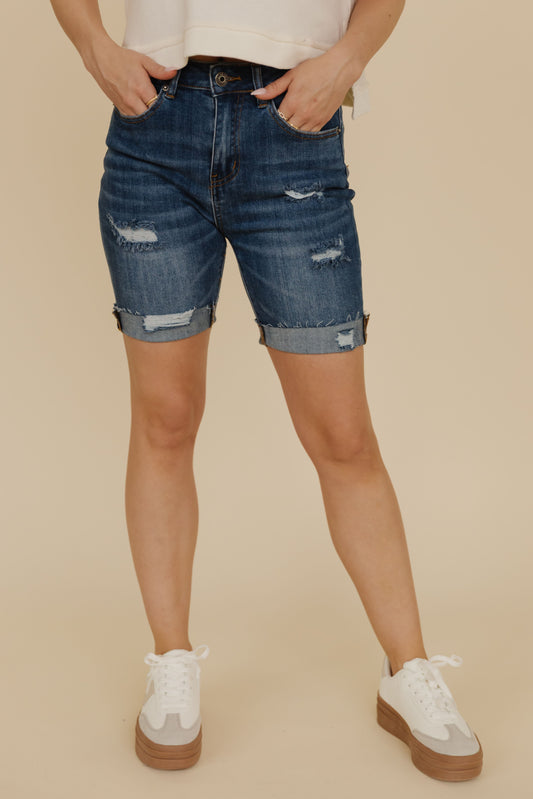 THE SCOUT HIGH RISE DISTRESSED SHORTS IN DARK DENIM